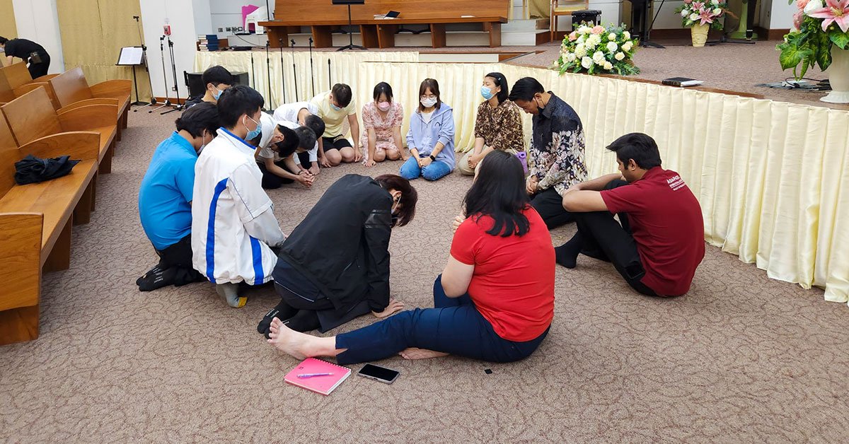 People kneeling in prayer on the church floor