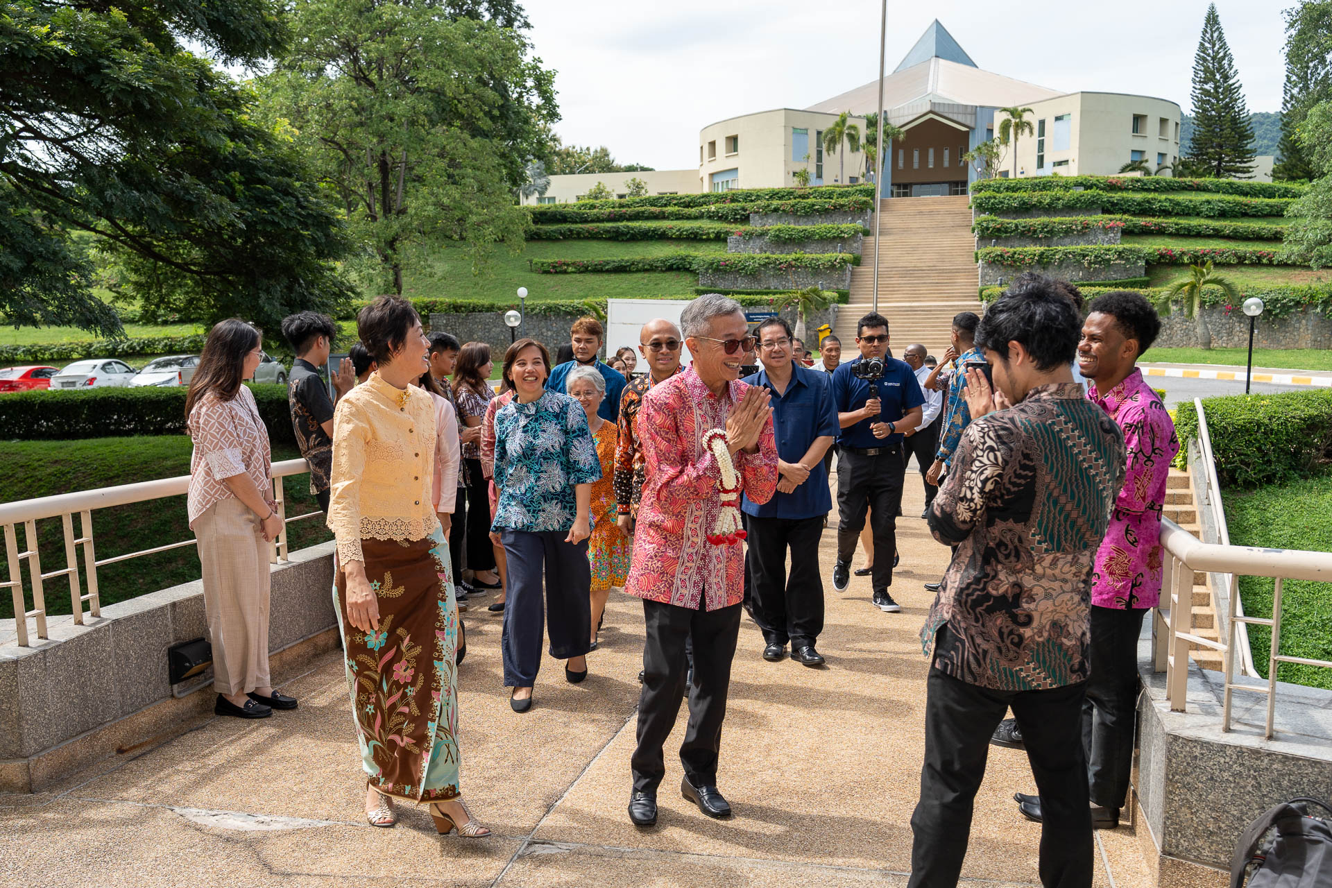His Excellency Rachmat Budiman, Indonesian Ambassador to Thailand (in red batik shirt and garland), being formally welcomed to the AIU campus by the university's President and delegation.