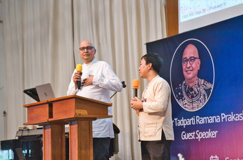 7 His Excellency Rachmat Budiman, Indonesian Ambassador to Thailand (in red batik shirt and garland), being formally welcomed to the AIU campus by the university's President and delegation.